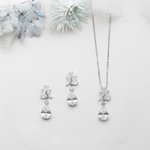 a collection of elegant jewelry pieces, including a necklace, earrings, and a bracelet, all adorned with large, sparkling diamonds.