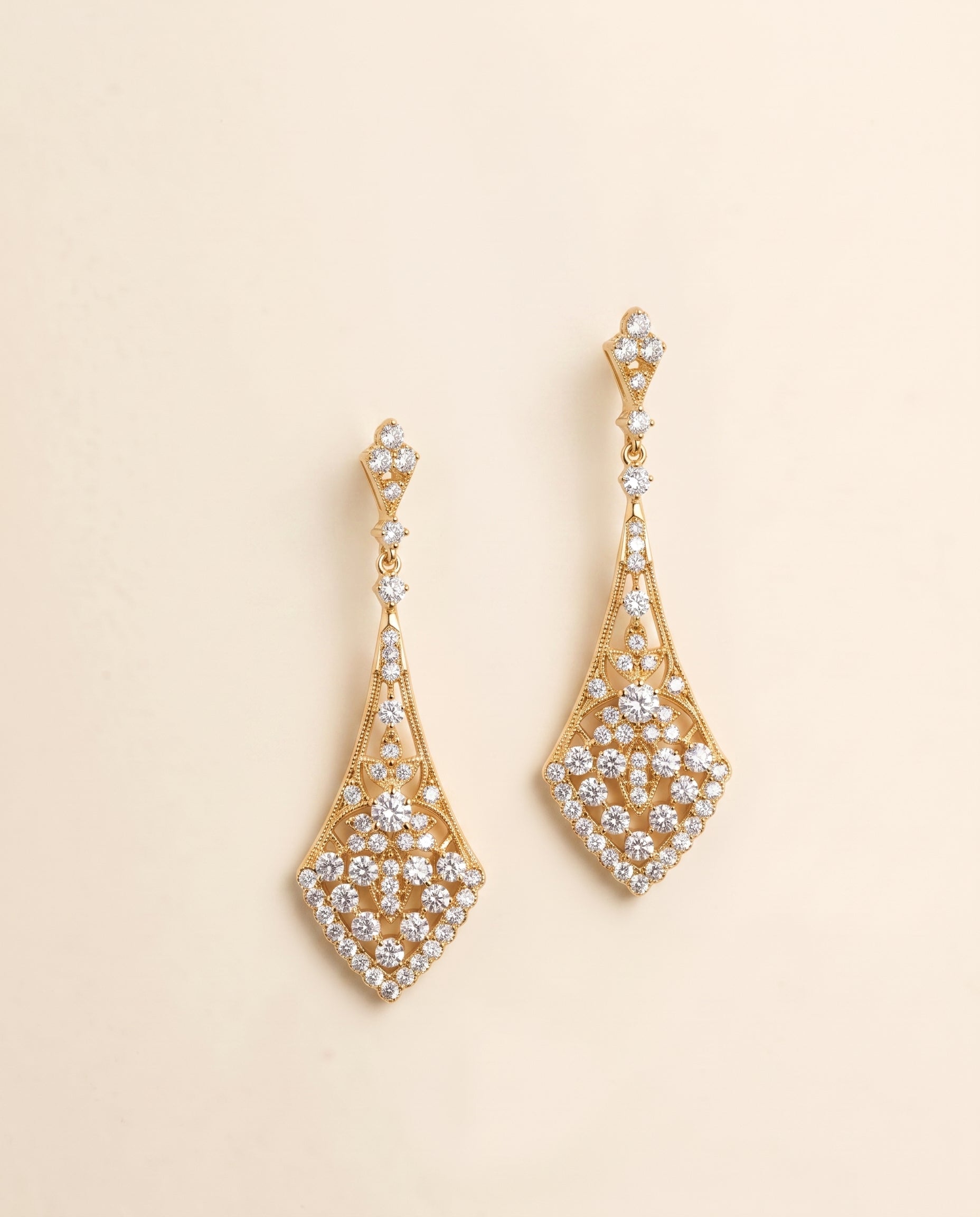 a pair of elegant gold earrings adorned with numerous sparkling diamonds.