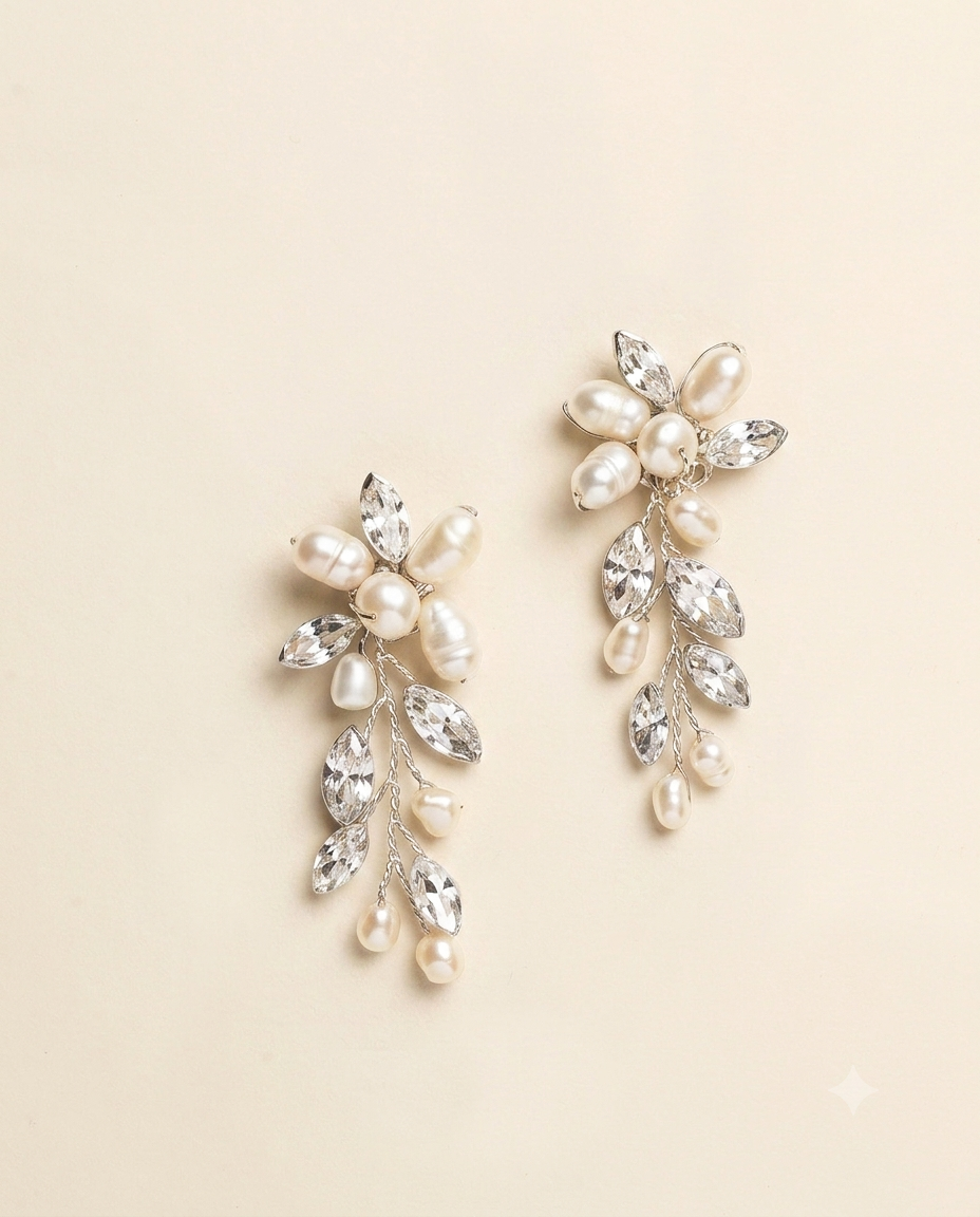 A pair of elegant earrings with a combination of pearls, crystals, and flowers.