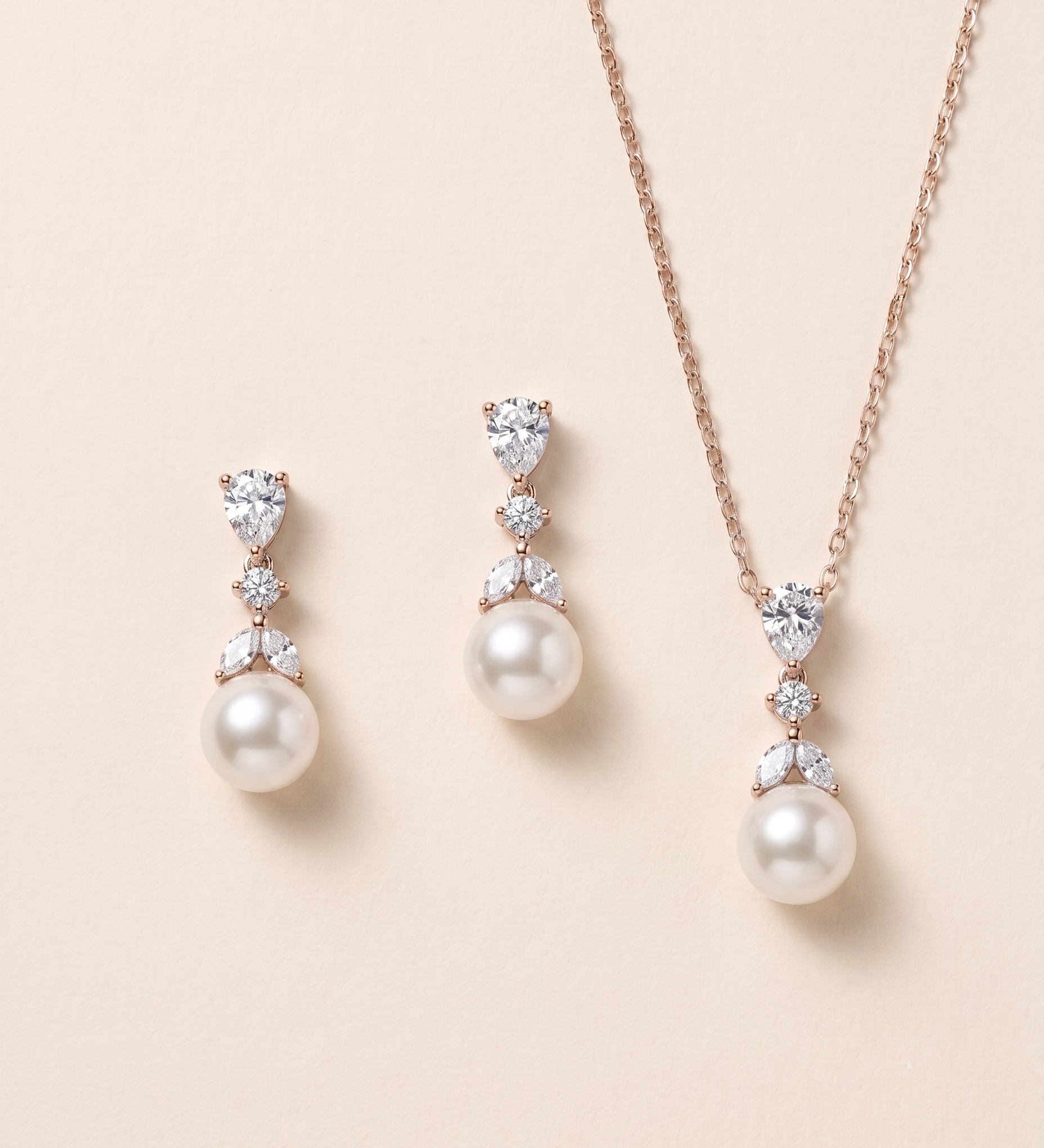 A necklace and earrings set with a combination of pearls and diamonds.