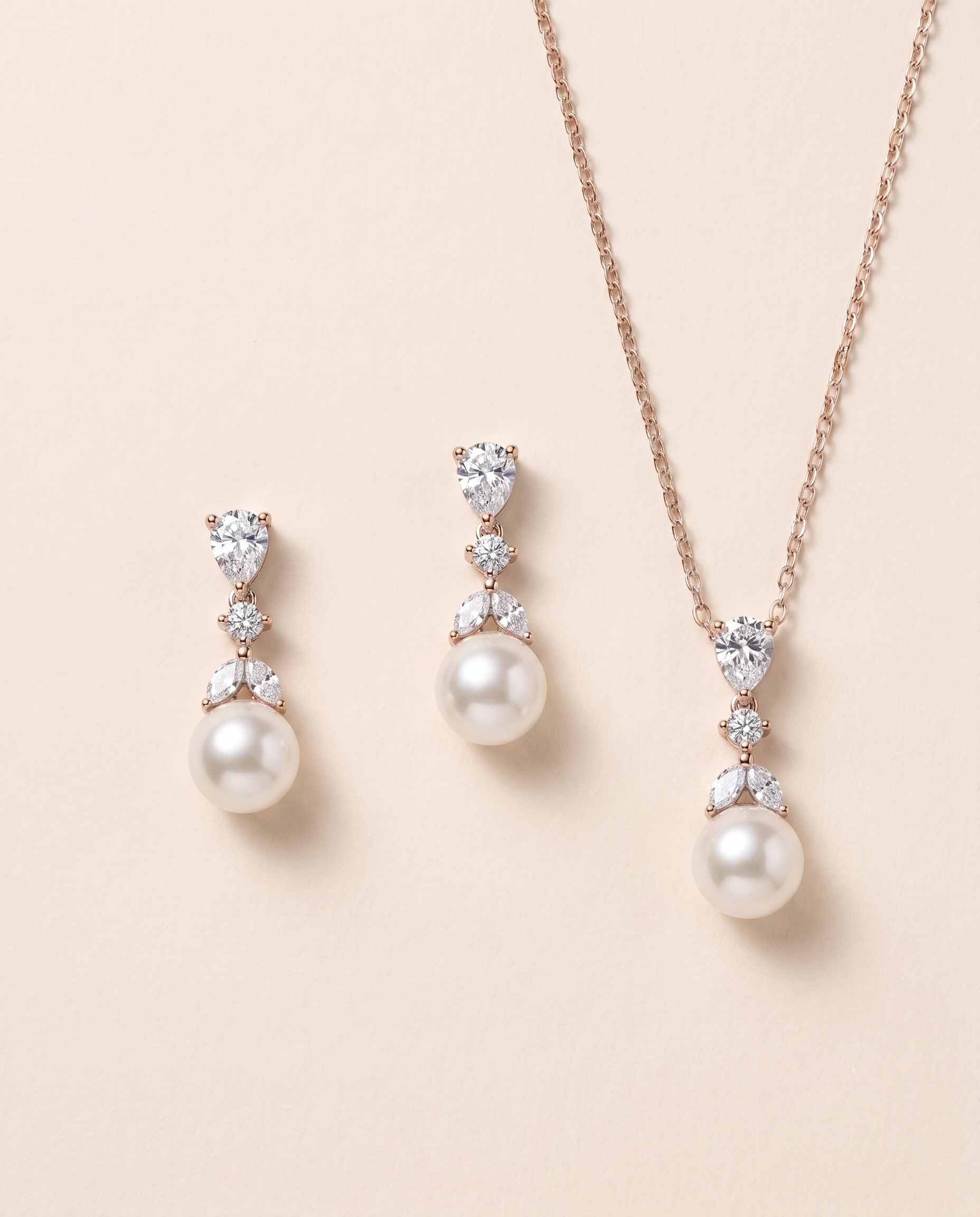 A necklace and earrings set with a combination of pearls and diamonds.