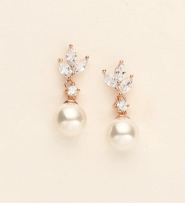 a pair of pearl and diamond earrings
