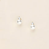 a pair of pearl and diamond earrings