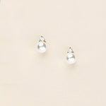a pair of pearl and diamond earrings