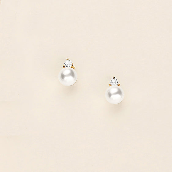 a pair of pearl and diamond earrings