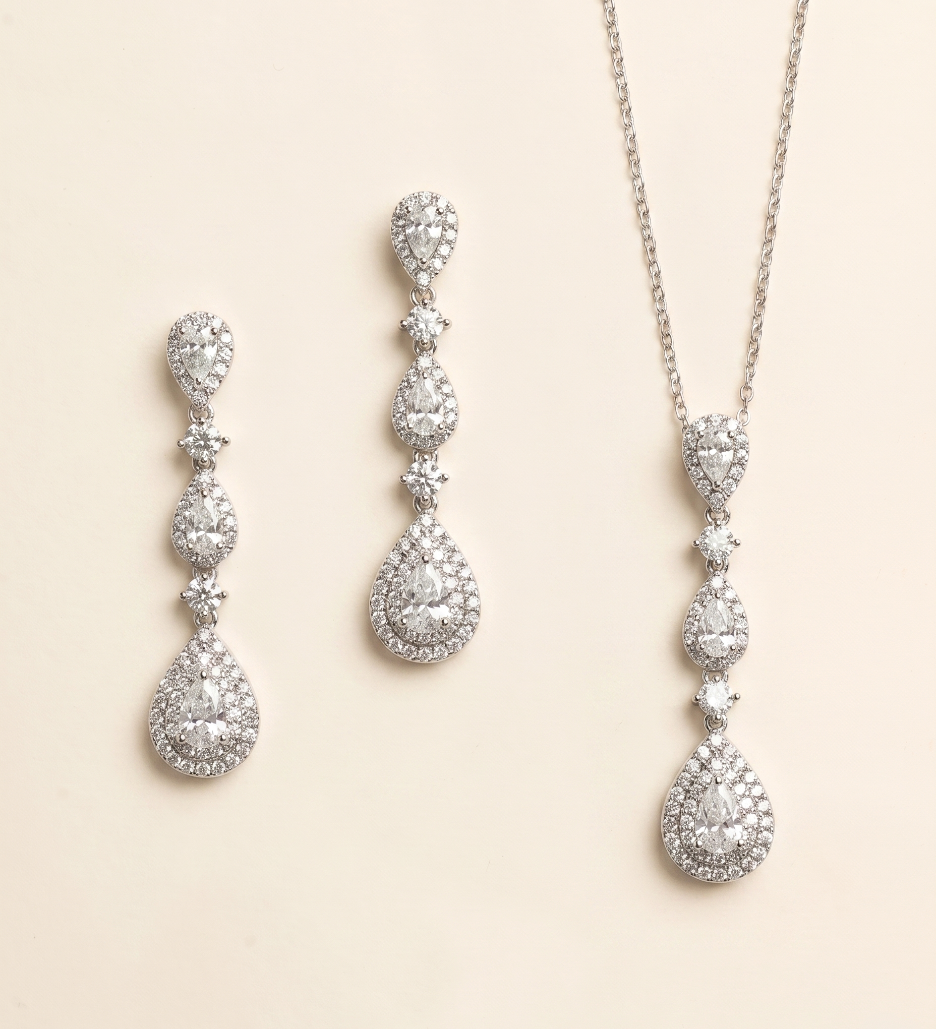 a set of elegant jewelry pieces, including earrings and a necklace, both adorned with numerous sparkling diamonds.