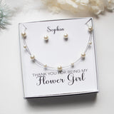A gift box containing a necklace and earrings, with a personalized message on the box.