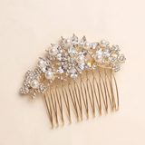 A gold-colored hair accessory with a floral design and numerous small pearls.