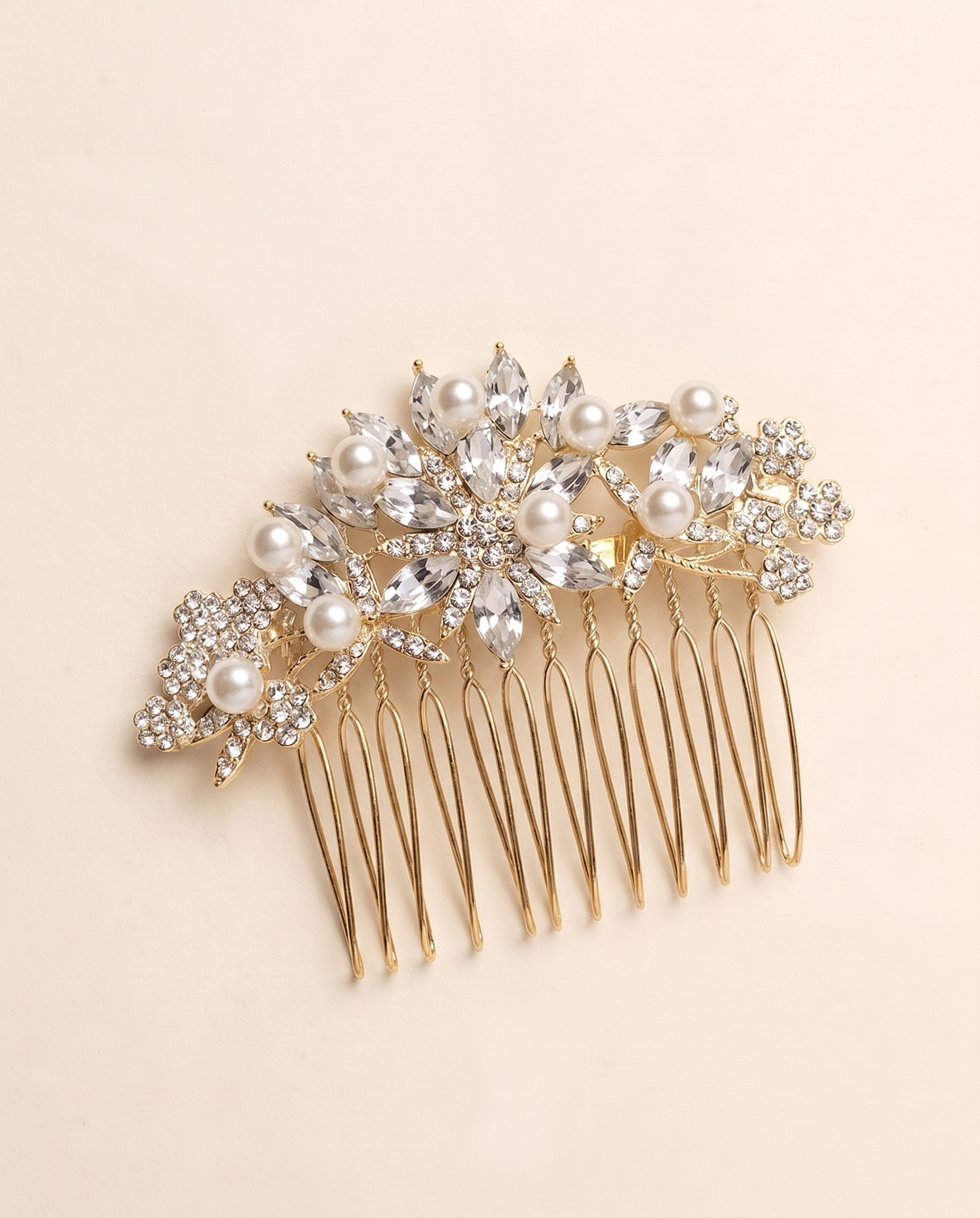 A gold-colored hair accessory with a floral design and numerous small pearls.