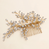A gold hairbrush adorned with a branch of clear crystal or gemstone-like stones.