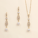 A set of three gold-colored jewelry pieces, including earrings and a necklace, with pearls and gemstones.