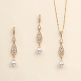A set of three gold-colored jewelry pieces, including earrings and a necklace, with pearls and gemstones.