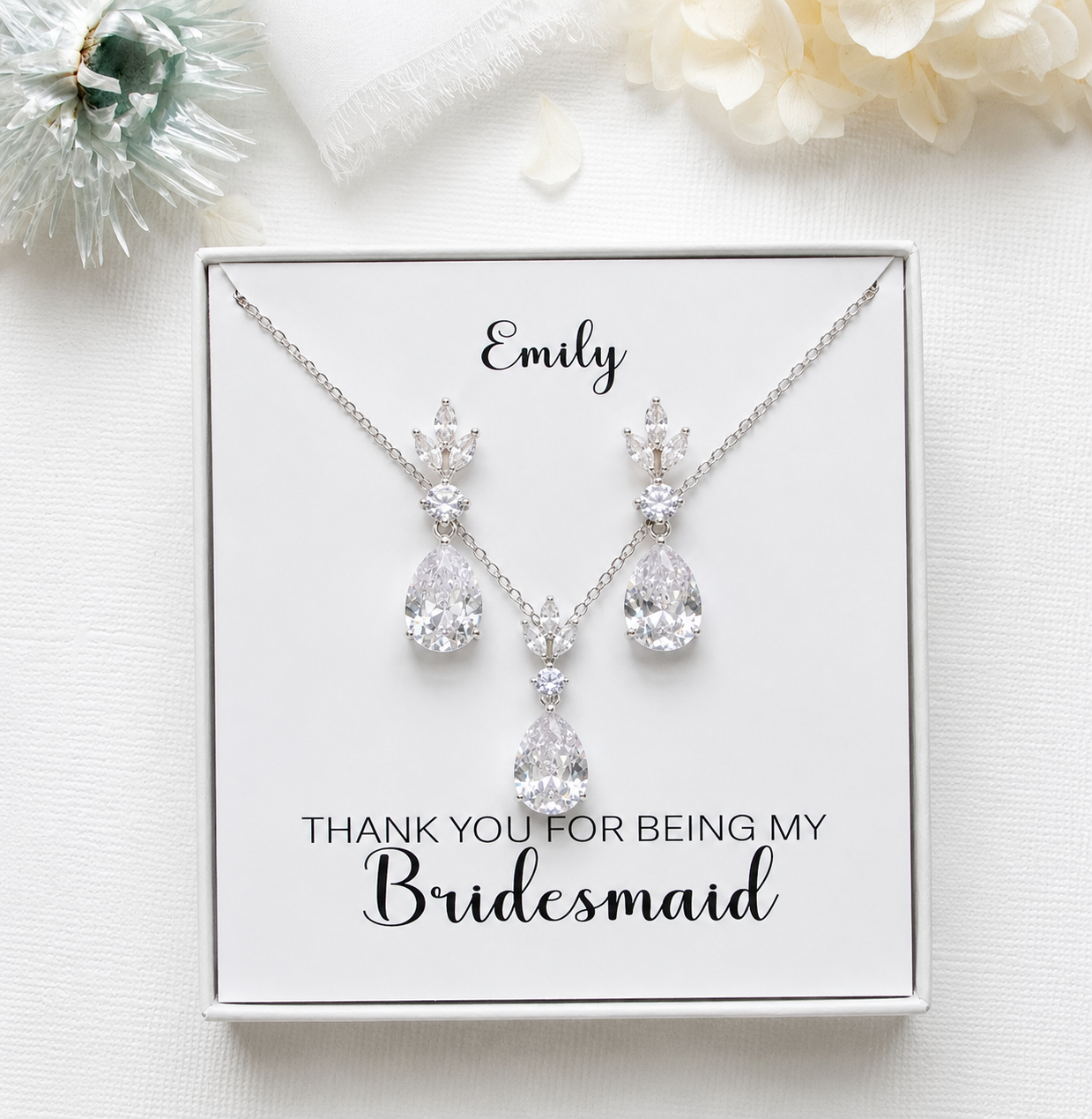 A necklace and earrings set with a personalized message, placed on a white background.