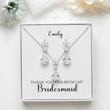 A necklace and earrings set with a personalized message, placed on a white background.