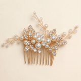 A decorative gold hairbrush adorned with pearls, crystals, and leaves.