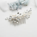 a close up of a hair comb with flowers in the background