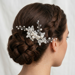 A woman's hair styled in a bun with a decorative hair accessory featuring pearls and crystals.