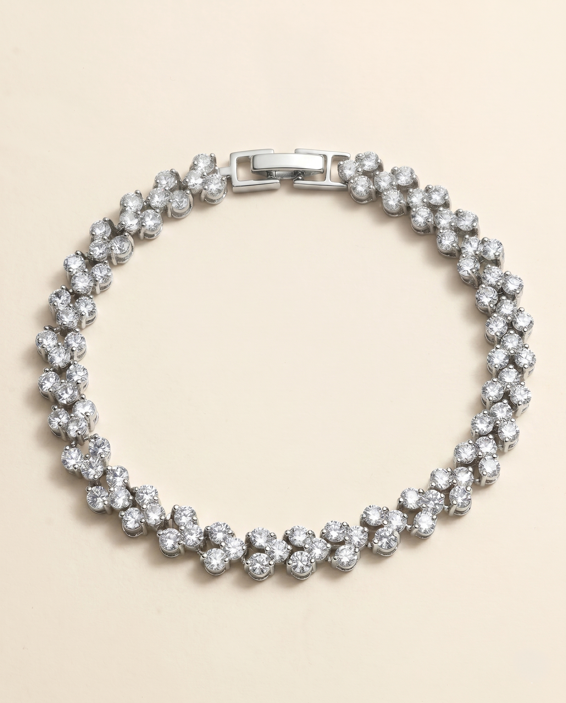 A silver bracelet adorned with numerous sparkling diamonds arranged in a circular pattern.