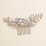 A decorative hair accessory with a comb and pearls.