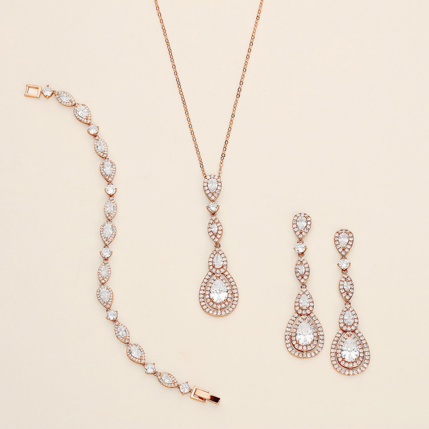 a necklace, bracelet, and earrings on a white surface