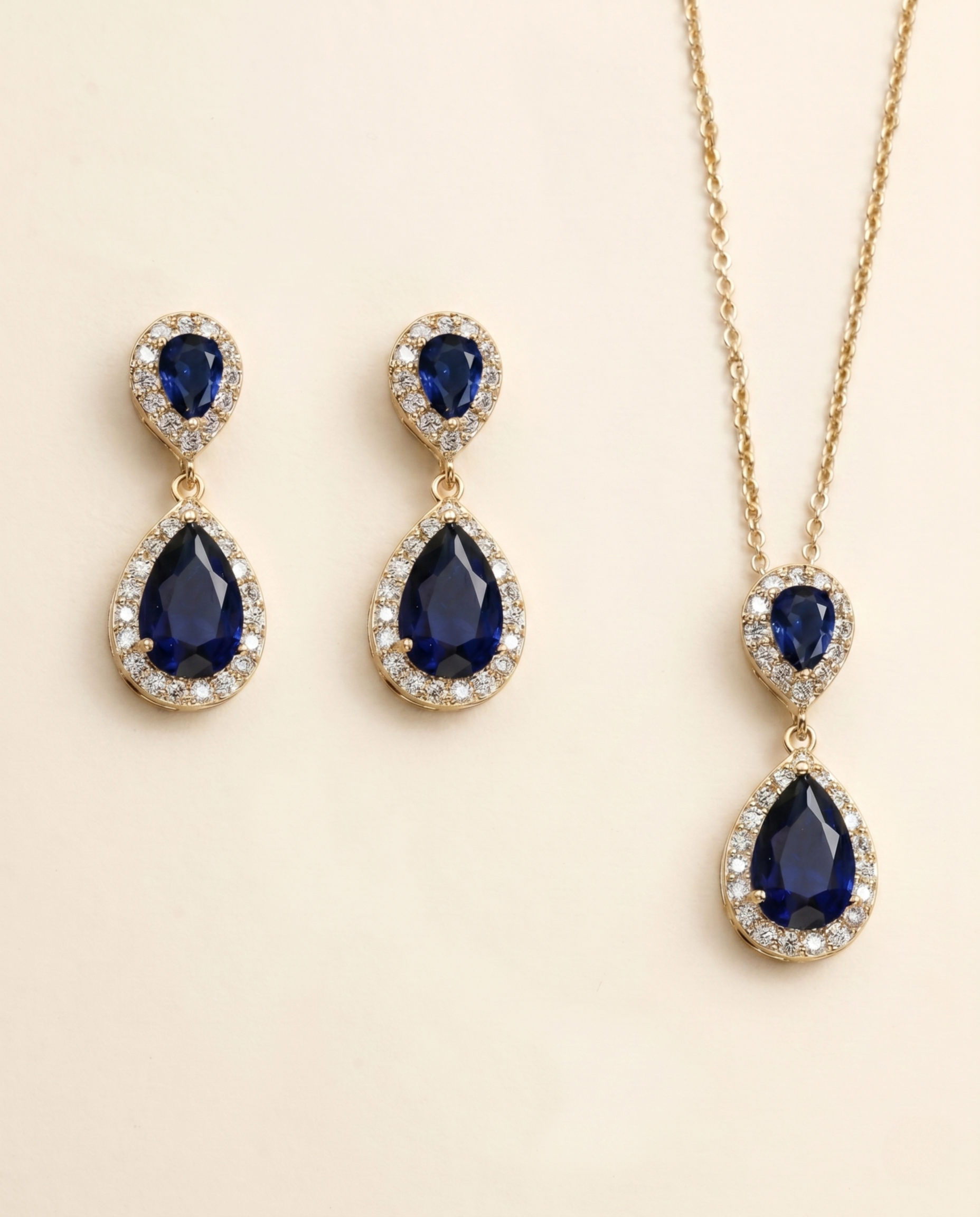 A set of elegant jewelry pieces, including earrings and a necklace, featuring large blue gemstones and sparkling diamonds.