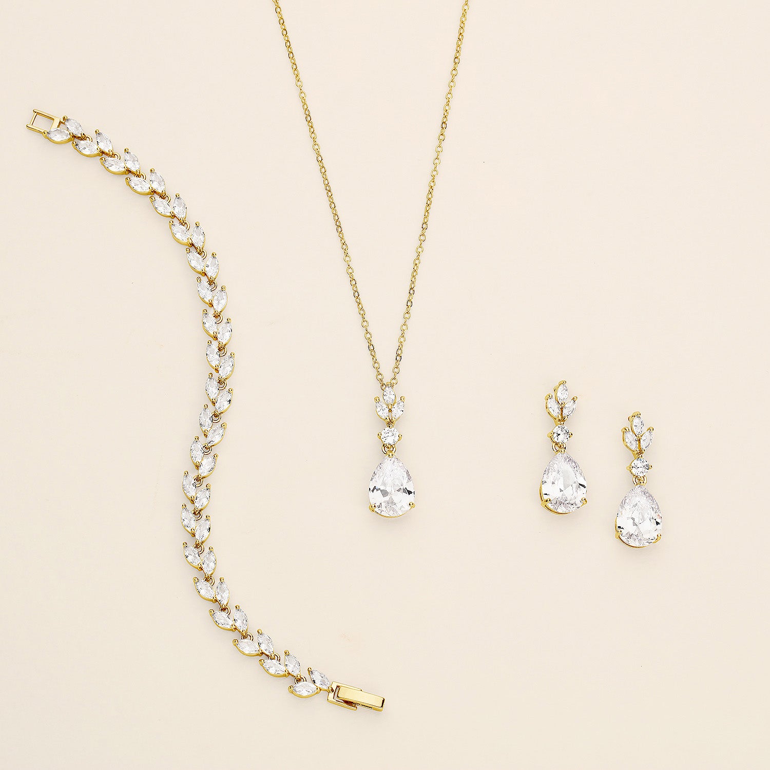a necklace, bracelet, and earrings on a white surface