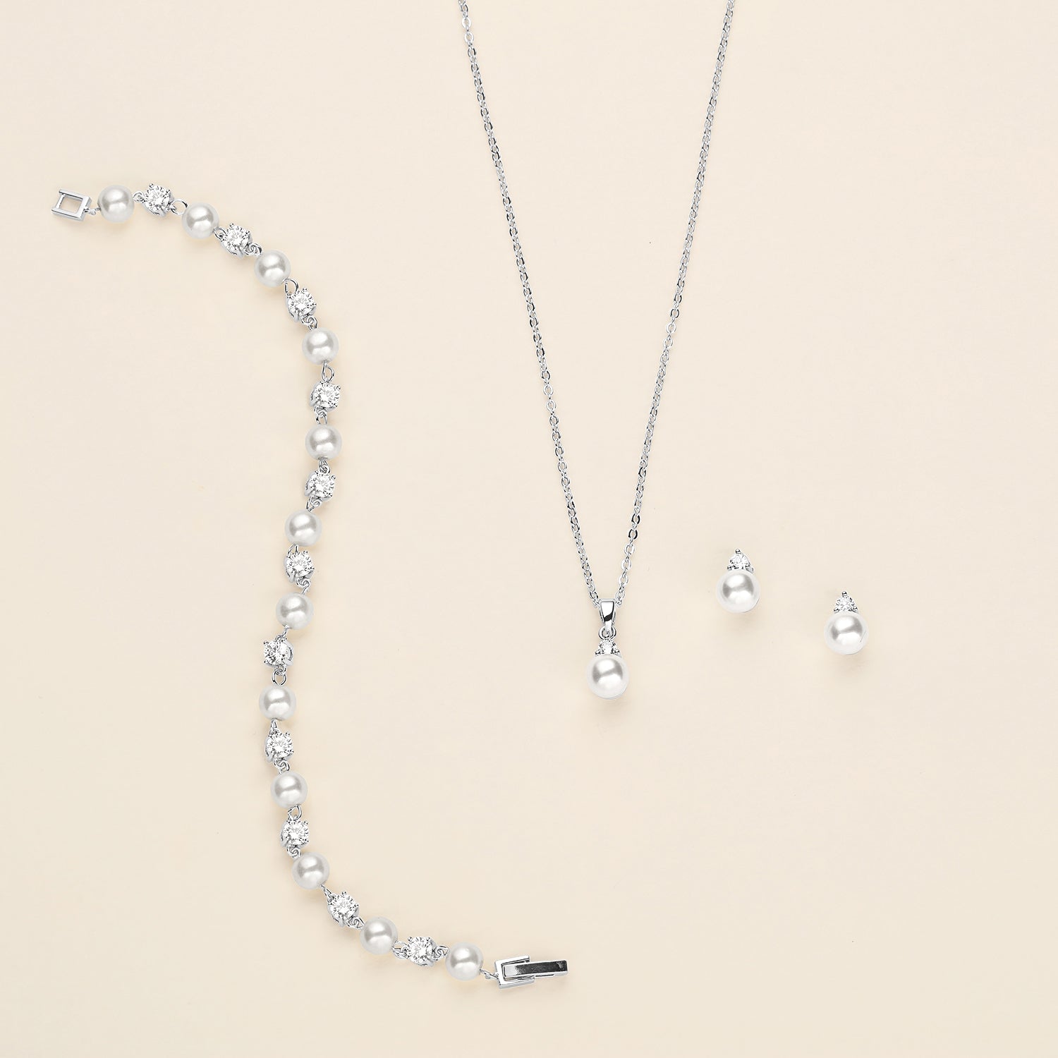 a necklace, earrings, and bracelet on a white surface