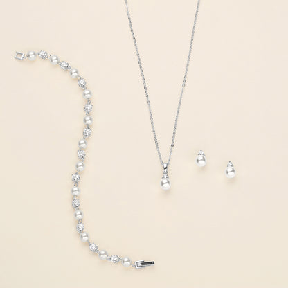 a necklace, earrings, and bracelet on a white surface