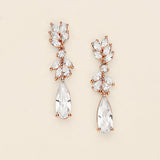 A pair of elegant earrings with clear gemstones and a delicate floral design.