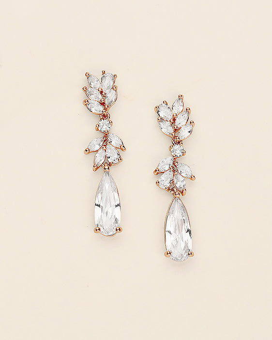 A pair of elegant earrings with clear gemstones and a delicate floral design.
