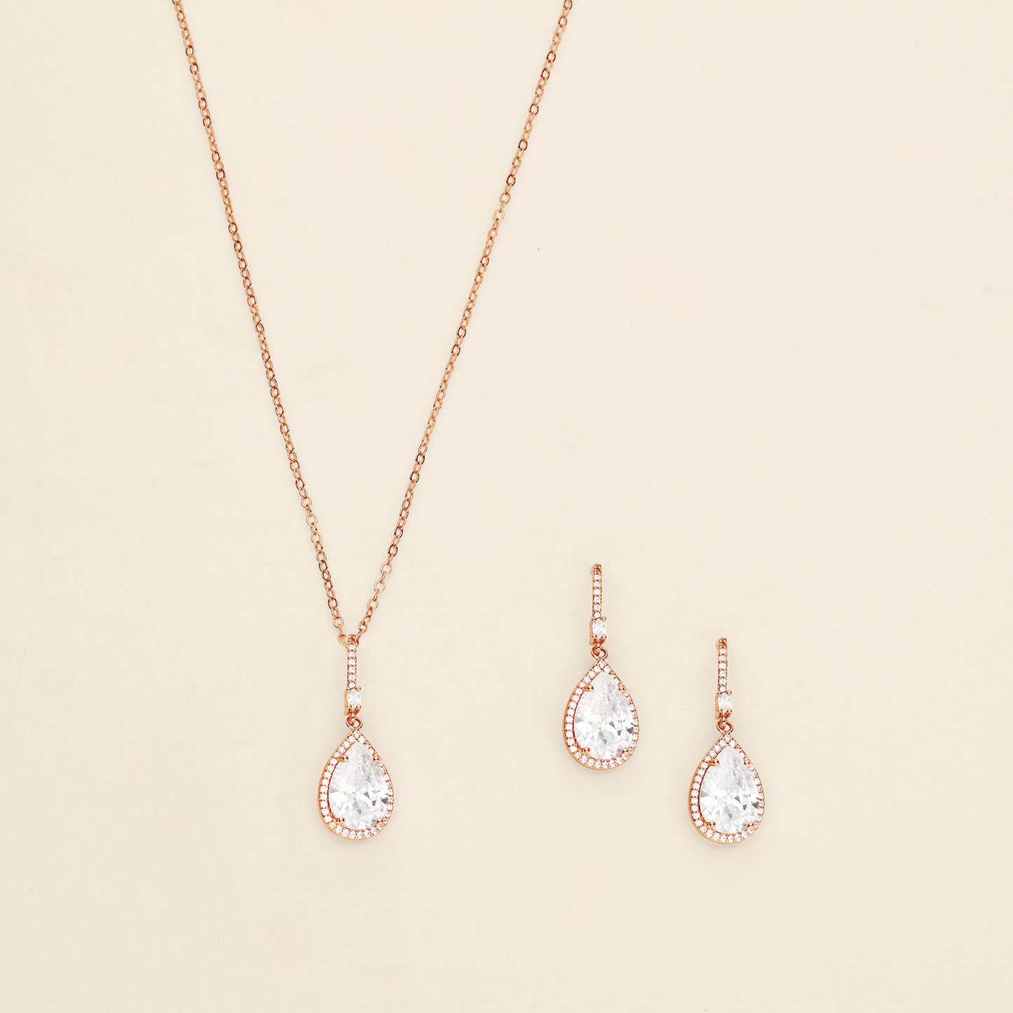 a necklace and earring set with a white diamond