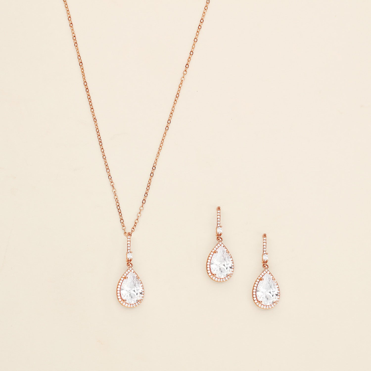 a necklace and earring set with a white diamond