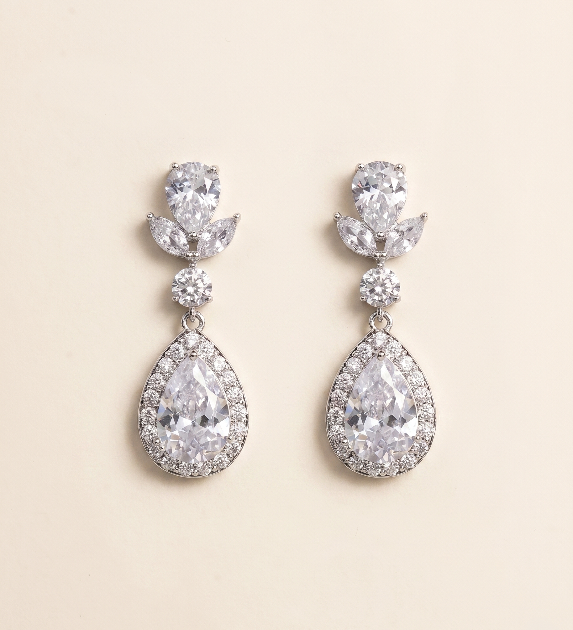 A pair of elegant earrings with large, clear gemstones set in a halo-like design.
