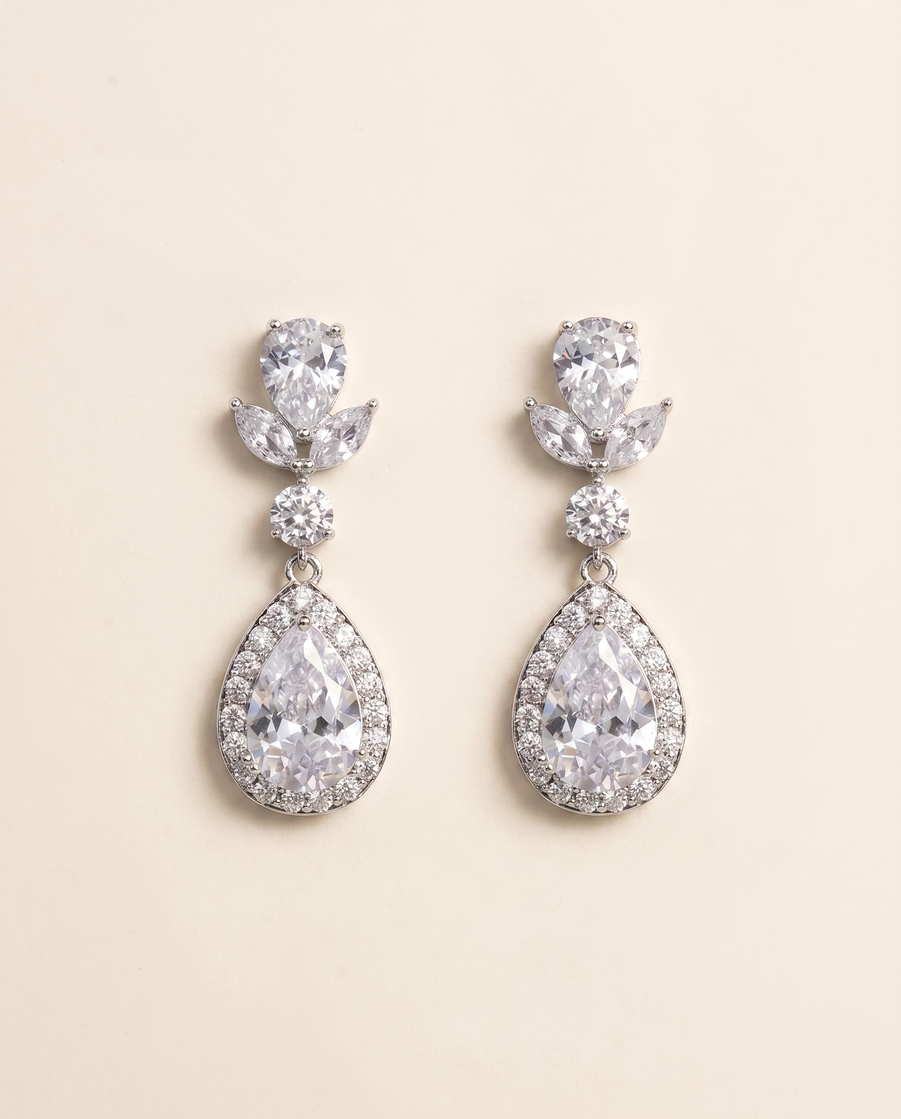 A pair of elegant earrings with large, clear gemstones set in a halo-like design.