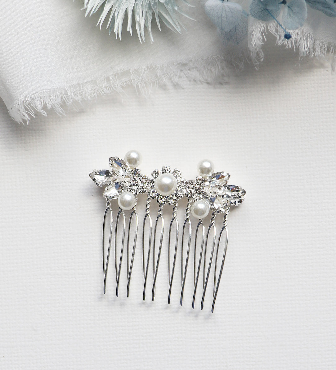 a close up of a hair comb with pearls