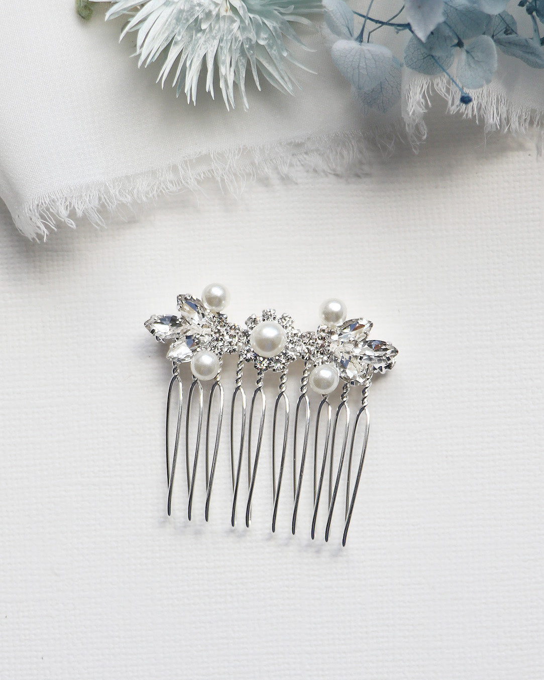 a close up of a hair comb with pearls