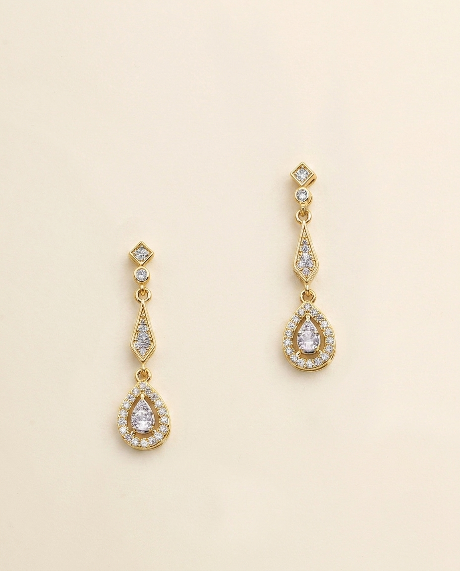 A pair of gold earrings with diamond-encrusted dangling designs.