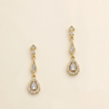 A pair of gold earrings with diamond-encrusted dangling designs.