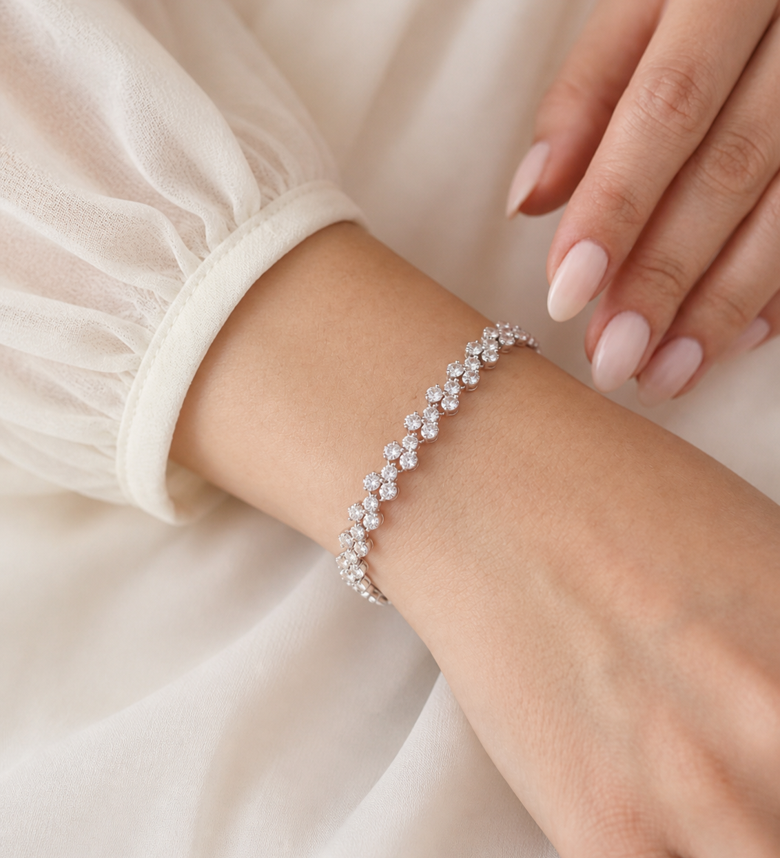 A close-up view of a person's wrist wearing a delicate bracelet adorned with small diamonds.