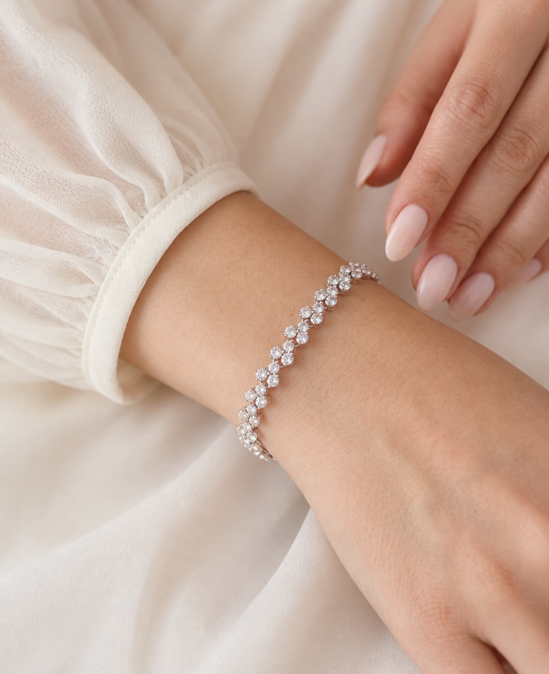 A close-up view of a person's wrist wearing a delicate bracelet adorned with small diamonds.