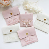 a collection of bridesmaid jewelry and accessories, including earrings and purses, arranged on a white background.