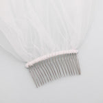 a hair comb with a white veil on top of it