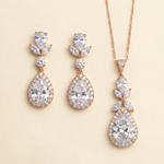 a set of elegant jewelry pieces, including a necklace and earrings, both adorned with large, sparkling diamonds.