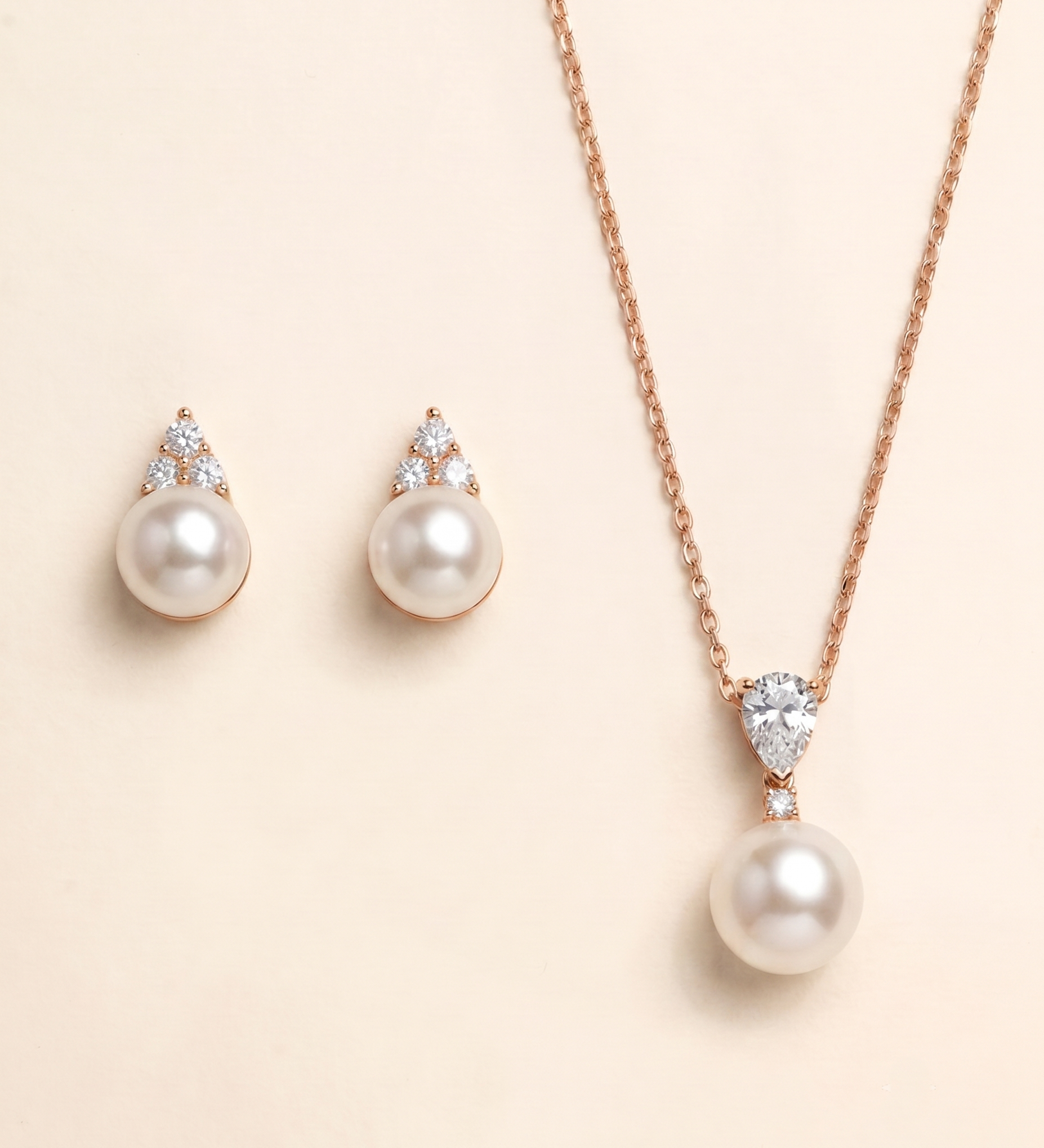 A necklace with a pendant and earrings made of pearls and diamonds.