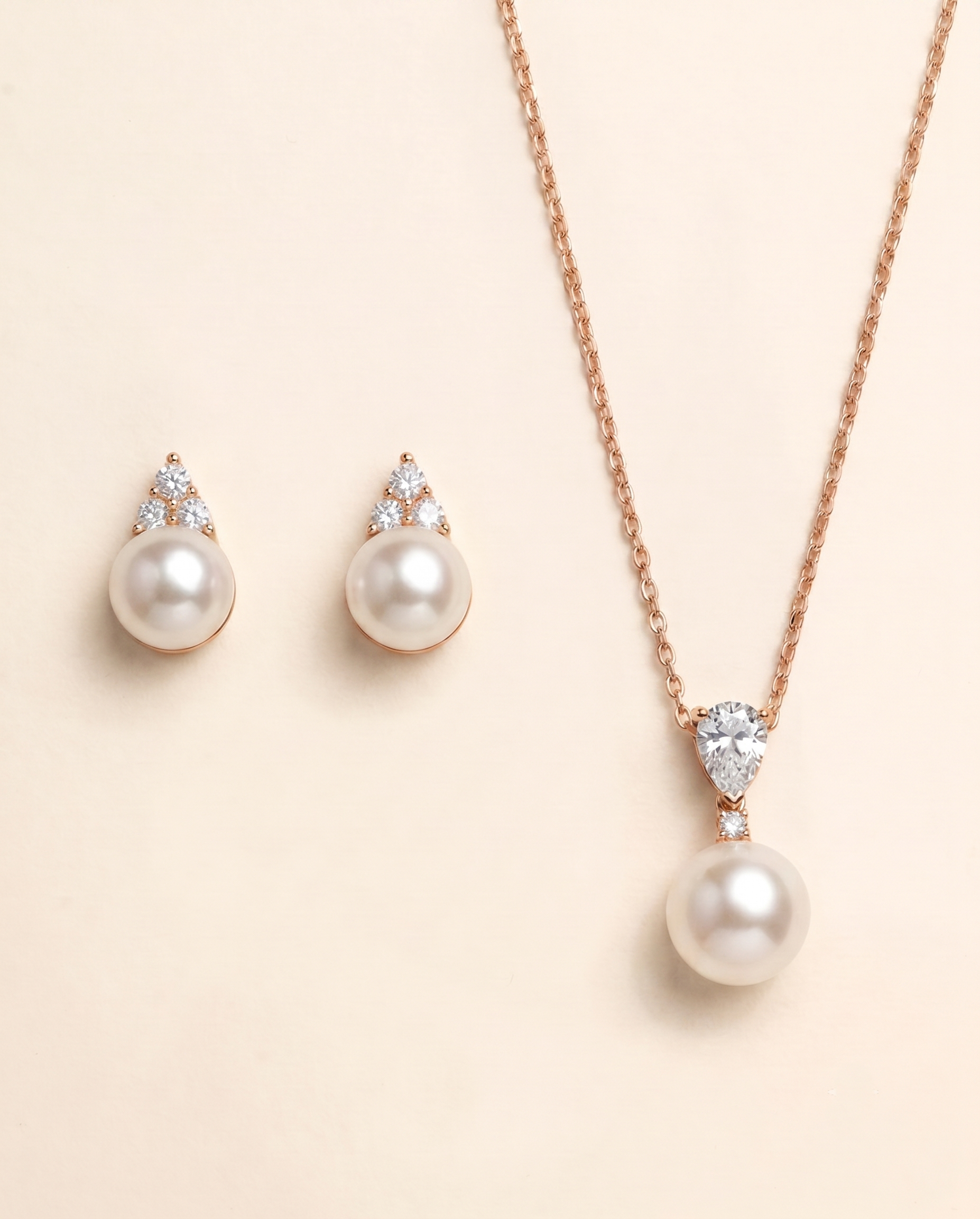 A necklace with a pendant and earrings made of pearls and diamonds.