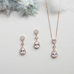 a necklace, earrings, and ring sitting on a table