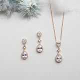 a necklace, earrings, and ring sitting on a table
