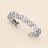 A silver bracelet adorned with numerous sparkling diamonds.