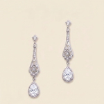 A pair of elegant diamond earrings with intricate designs and dangling crystal stones.