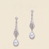 A pair of elegant diamond earrings with intricate designs and dangling crystal stones.